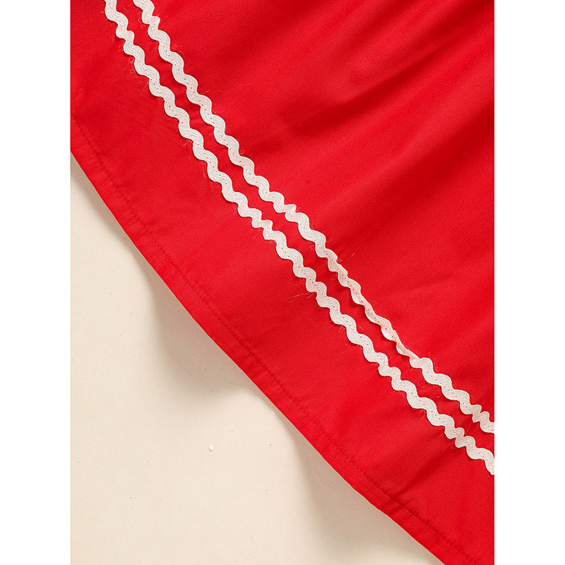 Red fabric with white lace trim on a beige background