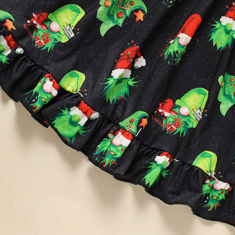 Black fabric with green and red Christmas-themed designs on a beige background