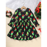 Black dress with Christmas tree and Santa hat pattern on a hanger against a white background.