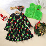 Black dress with Christmas elf pattern, green vest, and festive wreaths on a light background